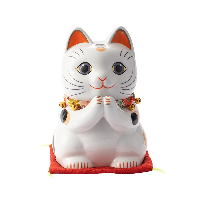 Close-up of a white ceramic lucky cat with colorful details.
