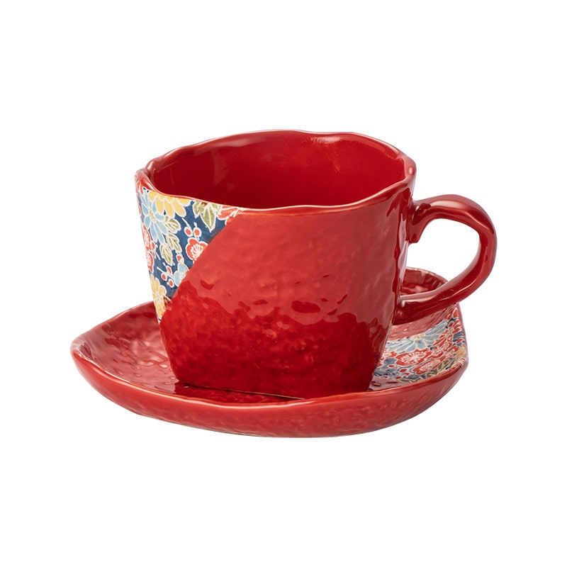 Vibrant red ceramic coffee mug on a textured wooden surface