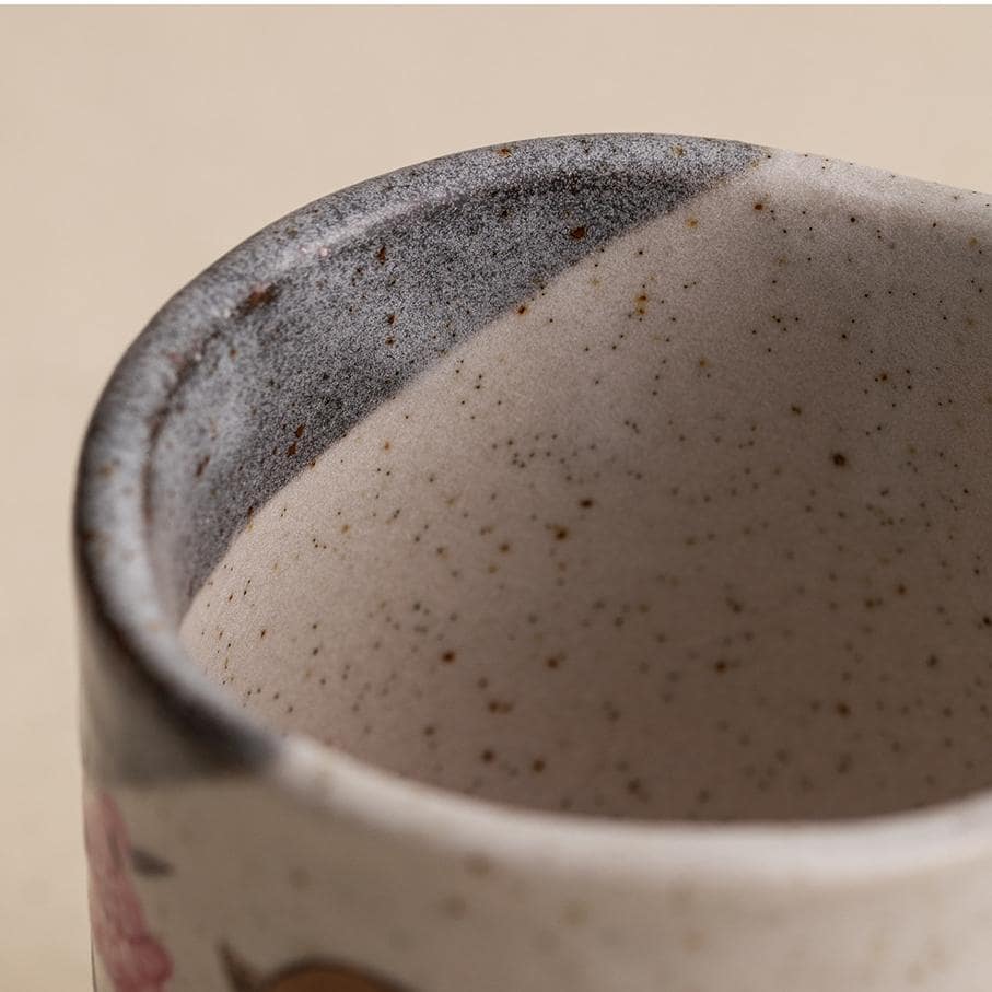 Artisanal ceramic tea cup showcasing spring-inspired details.