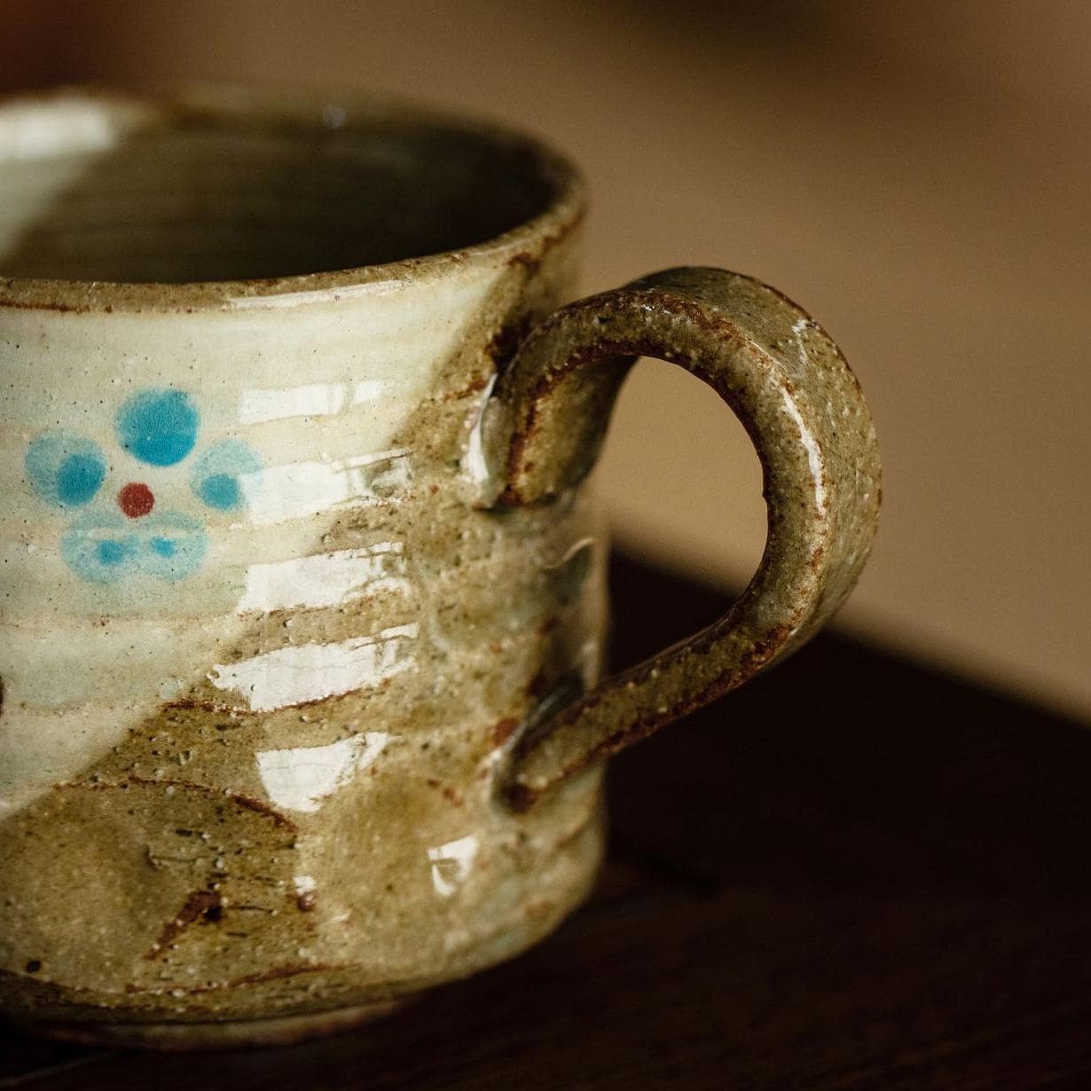 Close-up of a ceramic cup featuring a delicate flower pattern.