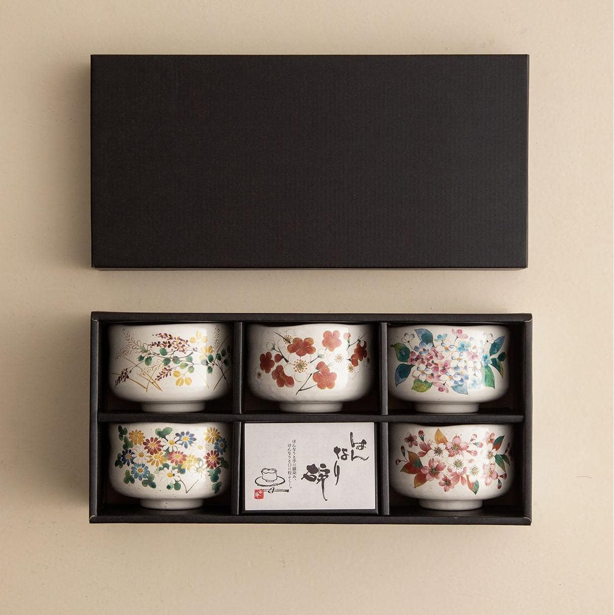 Hand-painted Japanese ceramic cups in elegant floral patterns