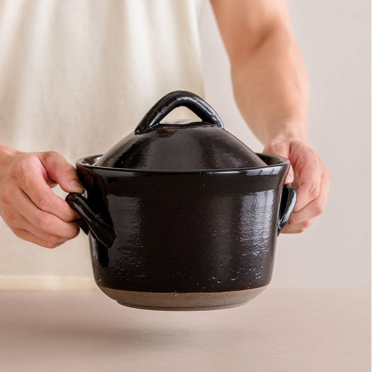 Handcrafted beige ceramic casserole with lid.