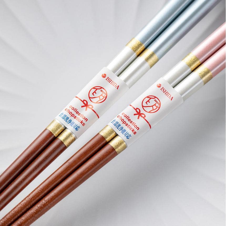 Close-up of durable wooden chopsticks with gold accents and smooth texture.