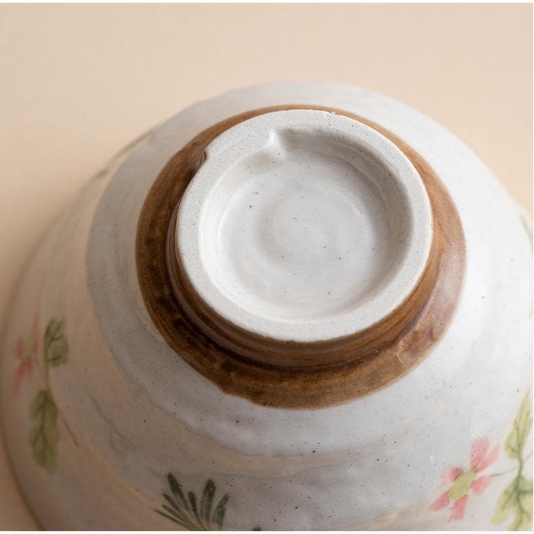 Ceramic bowl filled with soup on a wooden table