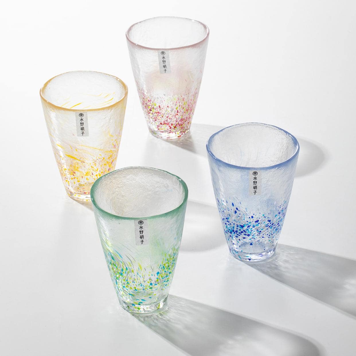 Handcrafted glass tumblers with vibrant swirl patterns