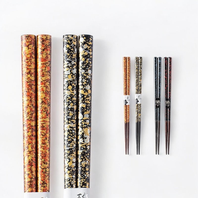 Single set of lacquered chopsticks with intricate gold design