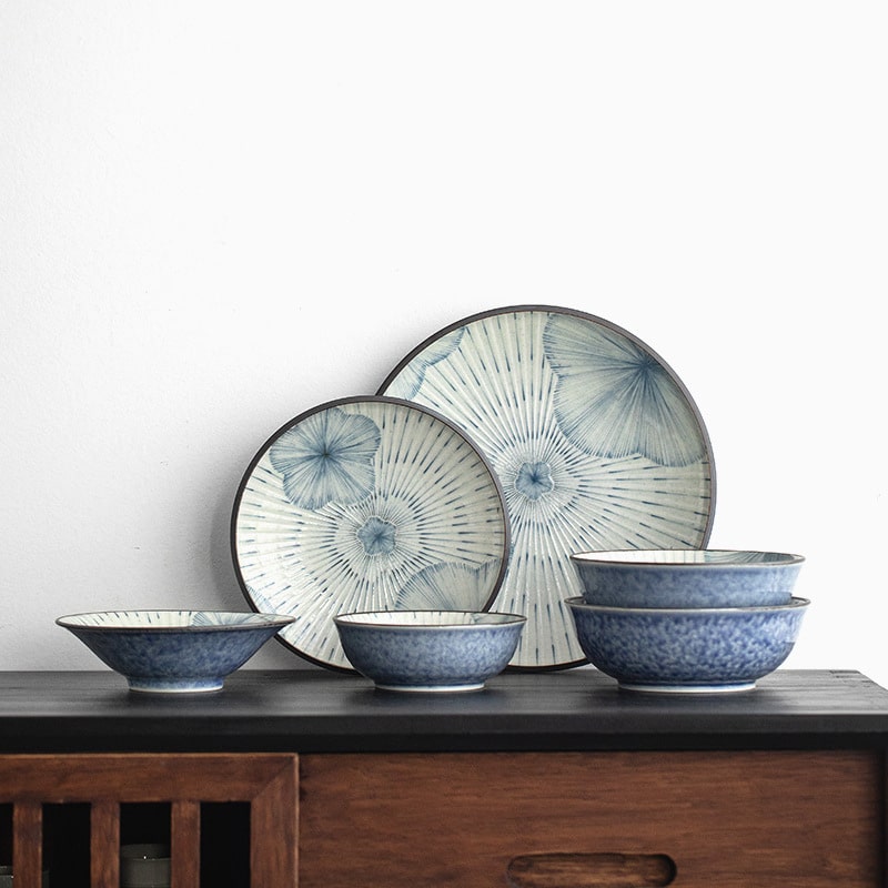 Japanese-inspired ceramic tableware set displayed on a black table