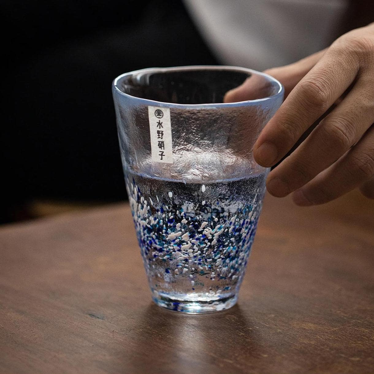 Artistic green and blue glass tumbler in natural light