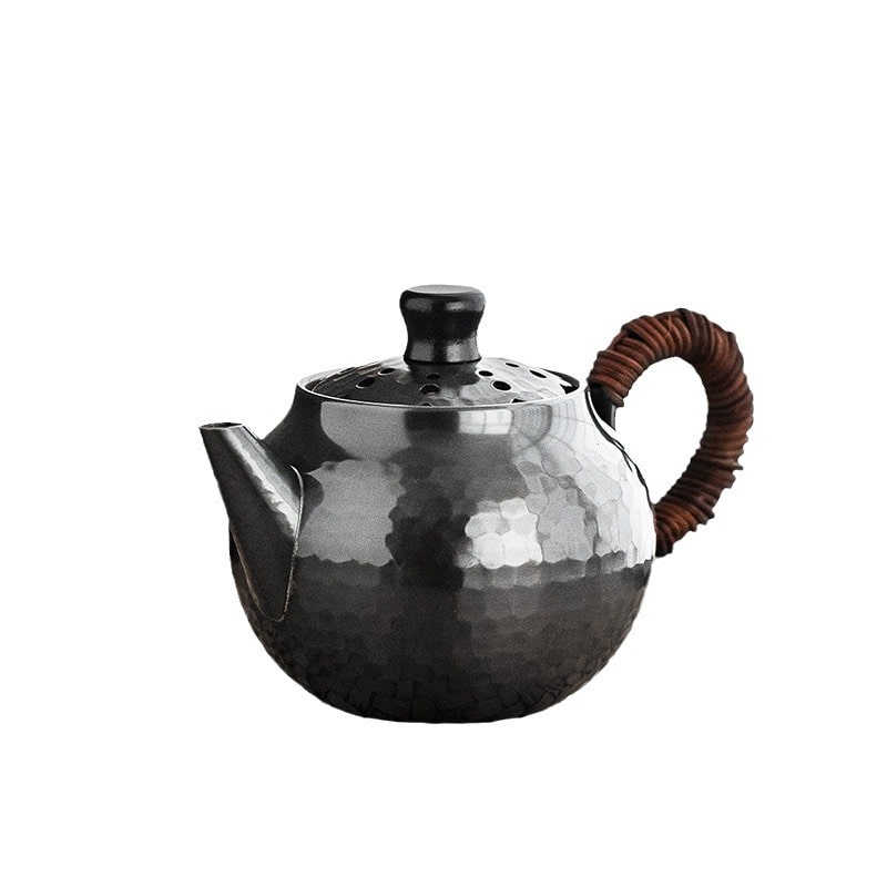 Stylish copper kettle with bamboo handle displayed on a wooden surface