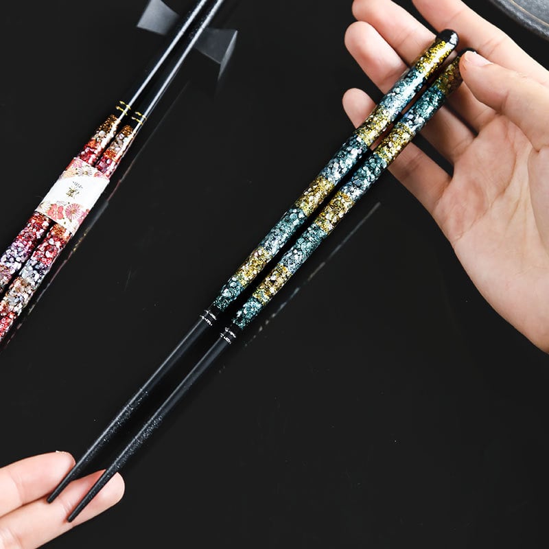 Close-up of premium chopsticks with shimmering floral design.