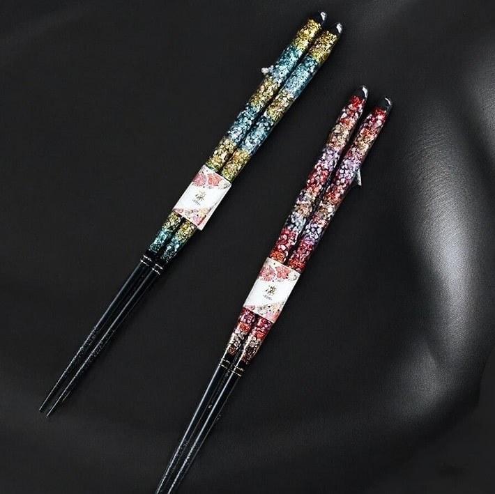 Pair of colorful floral-patterned chopsticks on display.