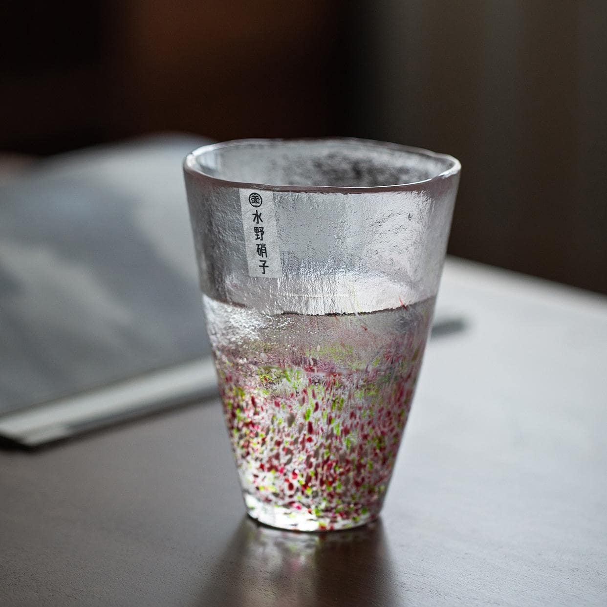 Artistic green and blue glass tumbler in natural light