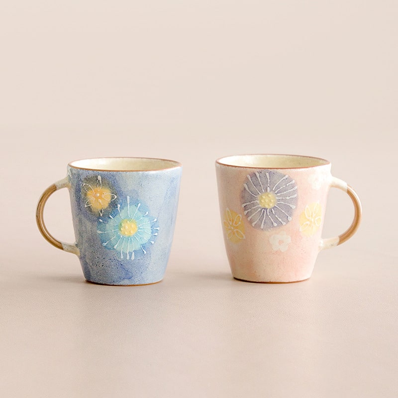 Pair of pink and blue ceramic cups with delicate flower designs