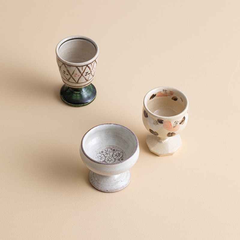 Ceramic cups set on a table, perfect for tea or wine