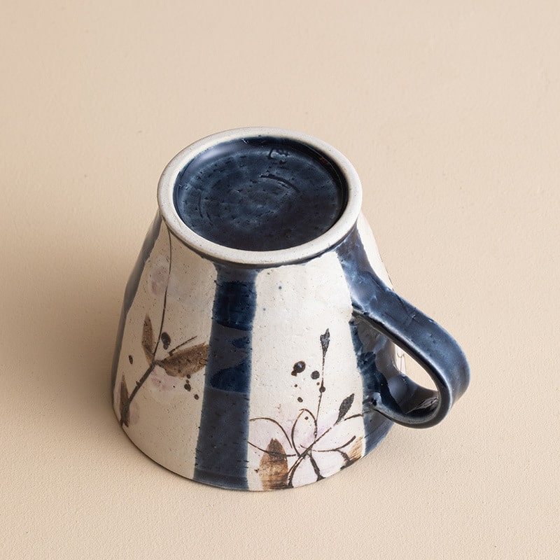 Close-up of a Japanese teacup showcasing floral hand-painted design