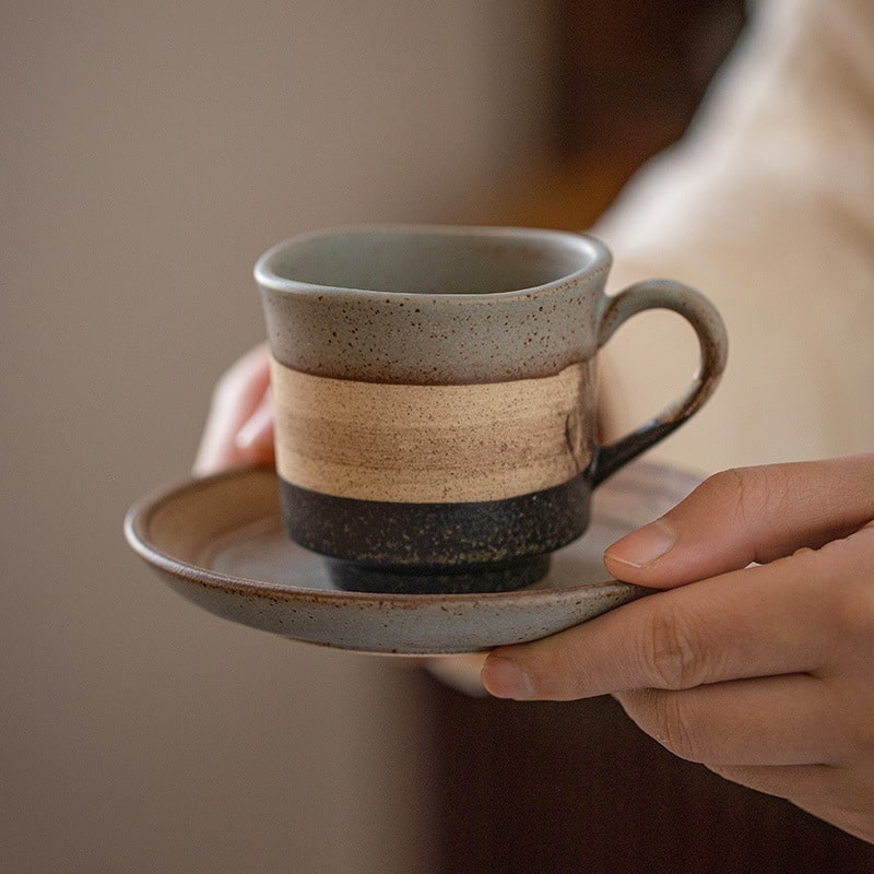 Elegant ceramic cup and saucer set for coffee or tea.