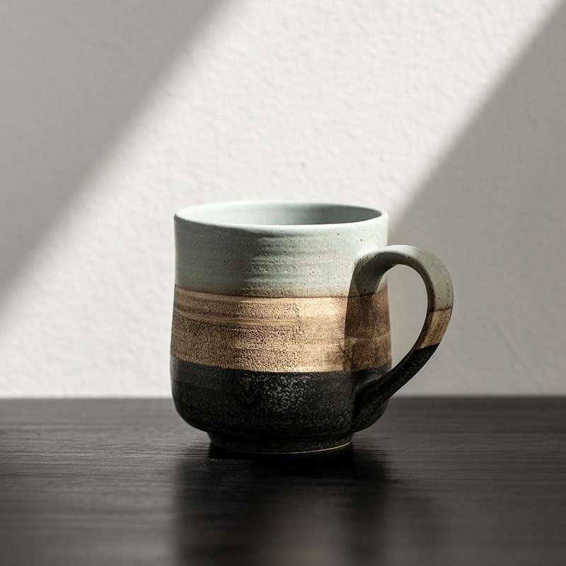 Artisan-crafted ceramic mug with a natural texture.