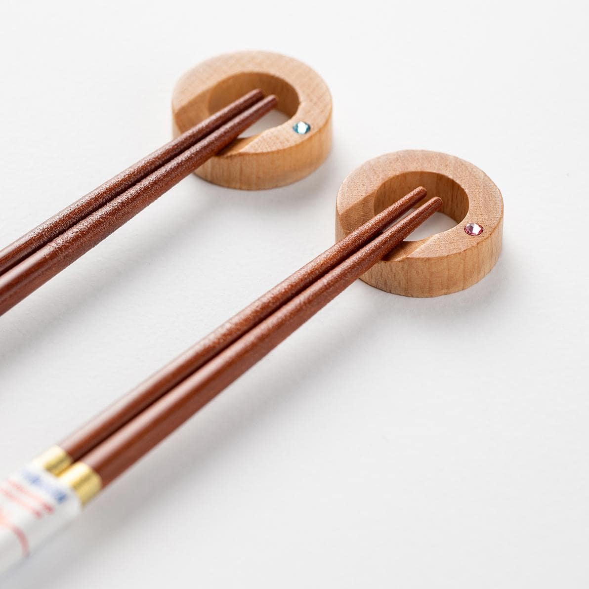 Close-up of durable wooden chopsticks with gold accents and smooth texture.