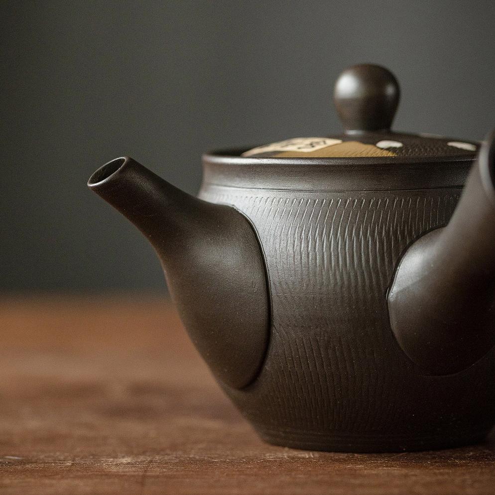 Elegant Japanese teapot on a wooden shelf