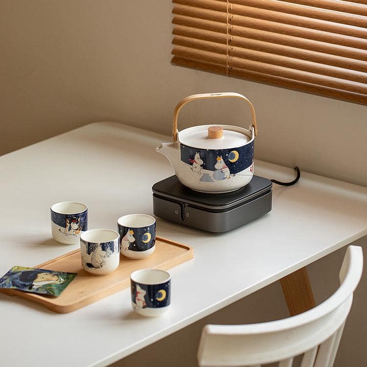 Moomin tea set in soft yellow tones, perfect for cozy tea moments.