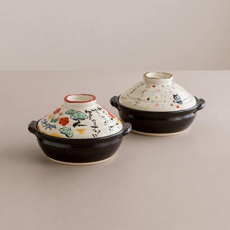 Two ceramic casserole pots showcasing unique Japanese artistry.