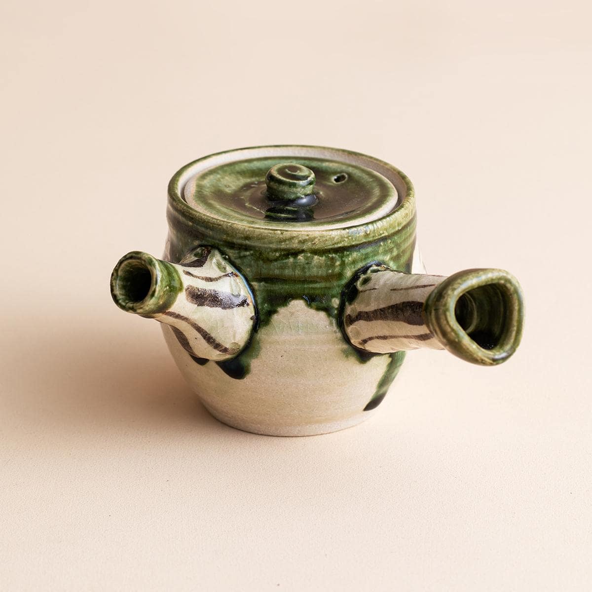 Side view of authentic Japanese Oribe Kyusu teapot with a green glaze.