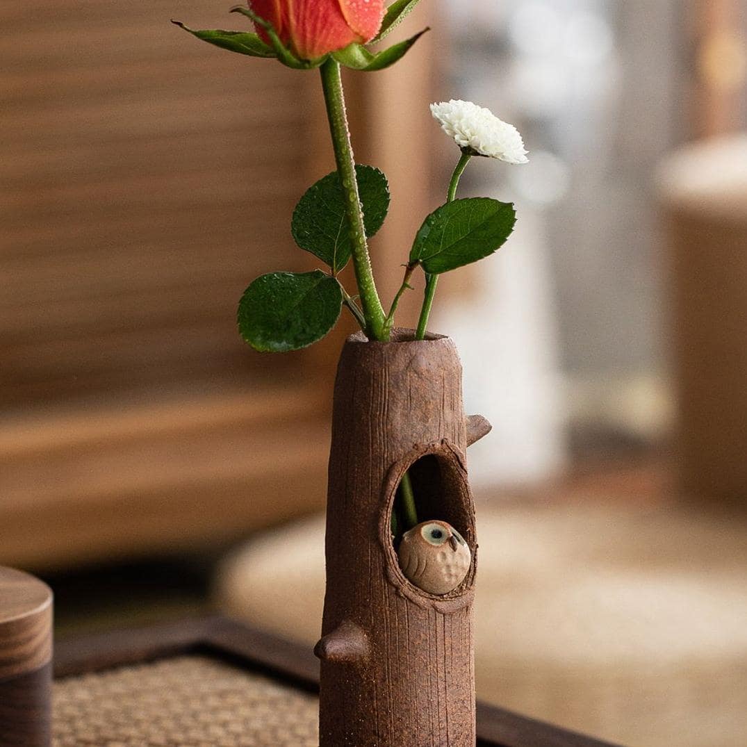 Close-up of Shinraku pottery cat incense holder on a brown tray.