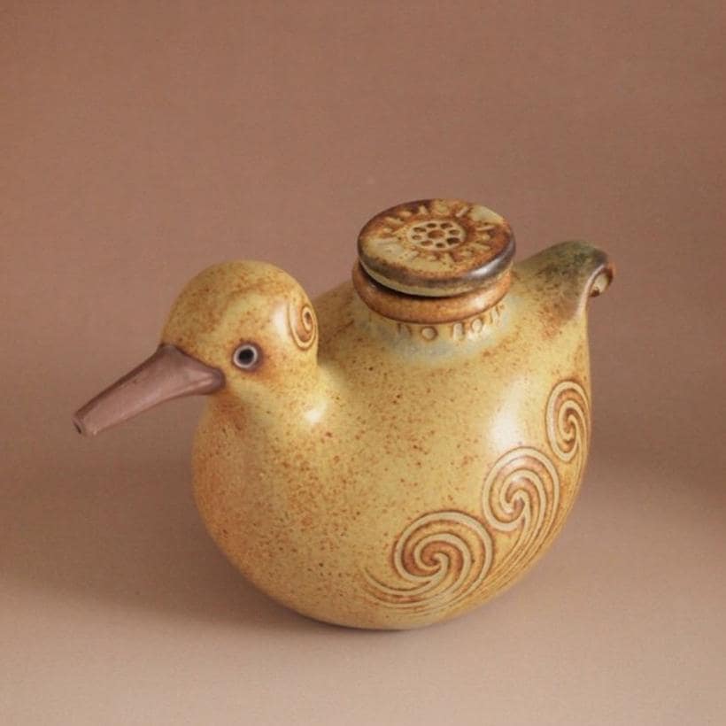 Handmade Japanese bird-shaped ceramic oil pot with swirl patterns.