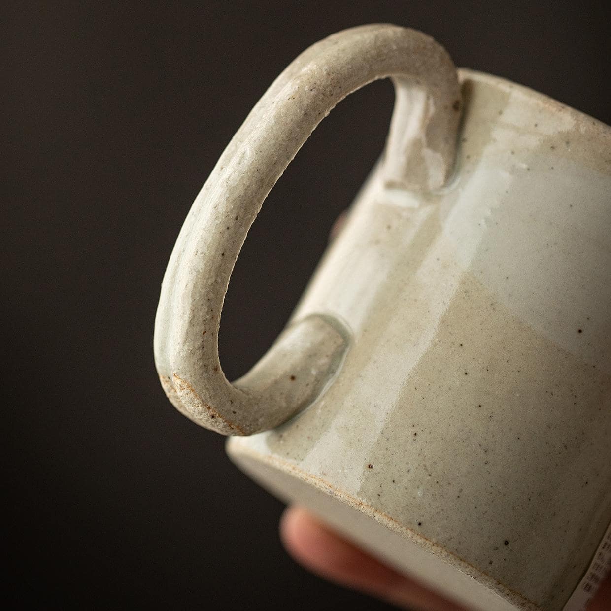 Hand holding retro-style Japanese rabbit coffee cup.