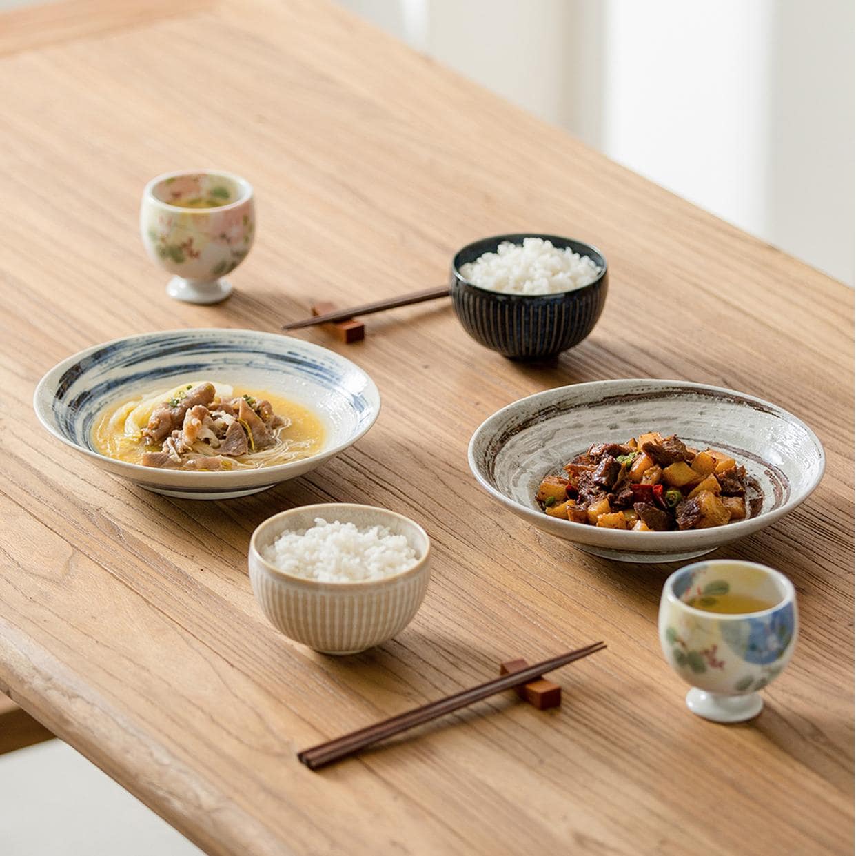 Stack of handcrafted ceramic plates in earthy tones