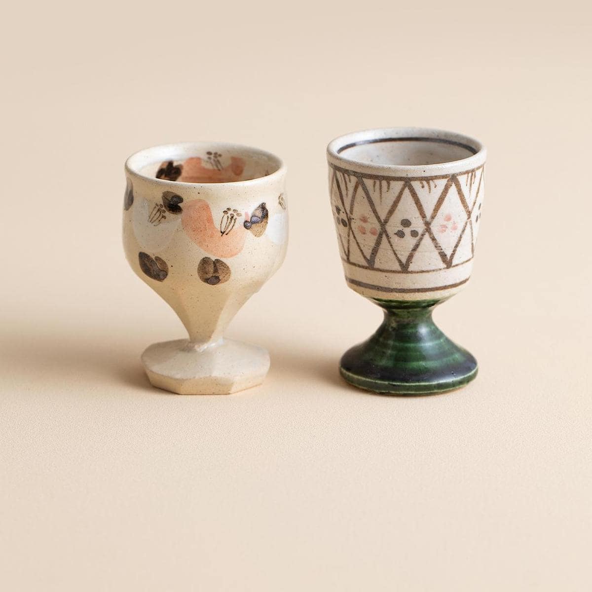 Pair of handcrafted ceramic cups with intricate designs