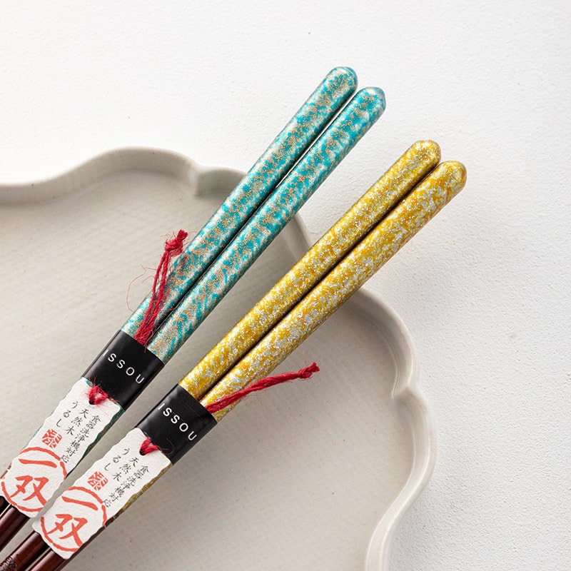 High-value Japanese chopsticks placed on a ceramic dish.