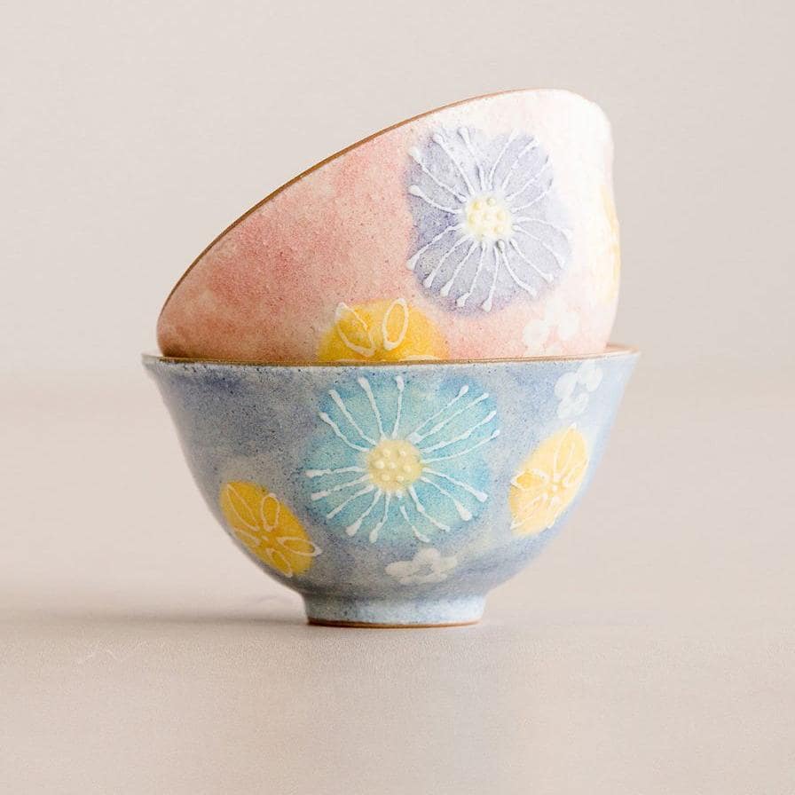 Two stackable pastel-colored Japanese bowls with floral patterns