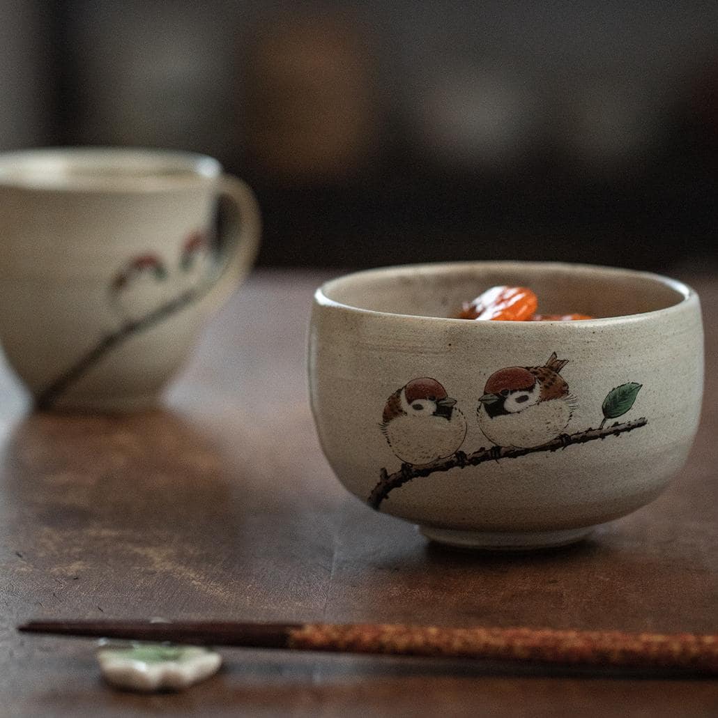 Close-up of handcrafted sparrow-pattern ceramic cup