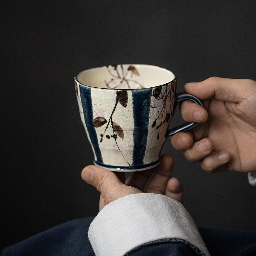 Close-up of a Japanese teacup showcasing floral hand-painted design