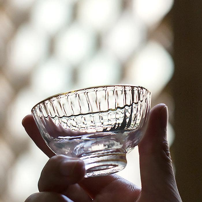 Close-up of Toyo Sasaki gold-trimmed glass cup on a table