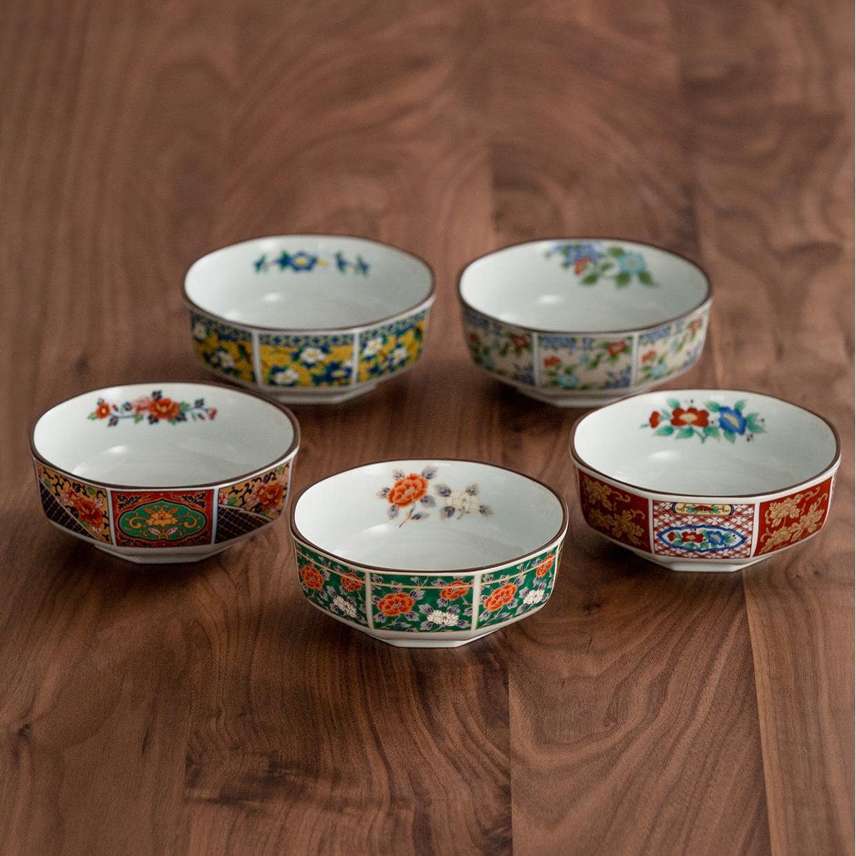 Set of five ceramic soup bowls with intricate Japanese designs.