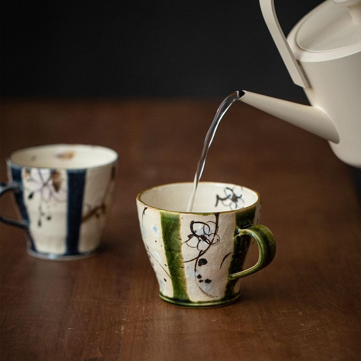 Pair of Japanese ceramic mugs with unique rustic charm