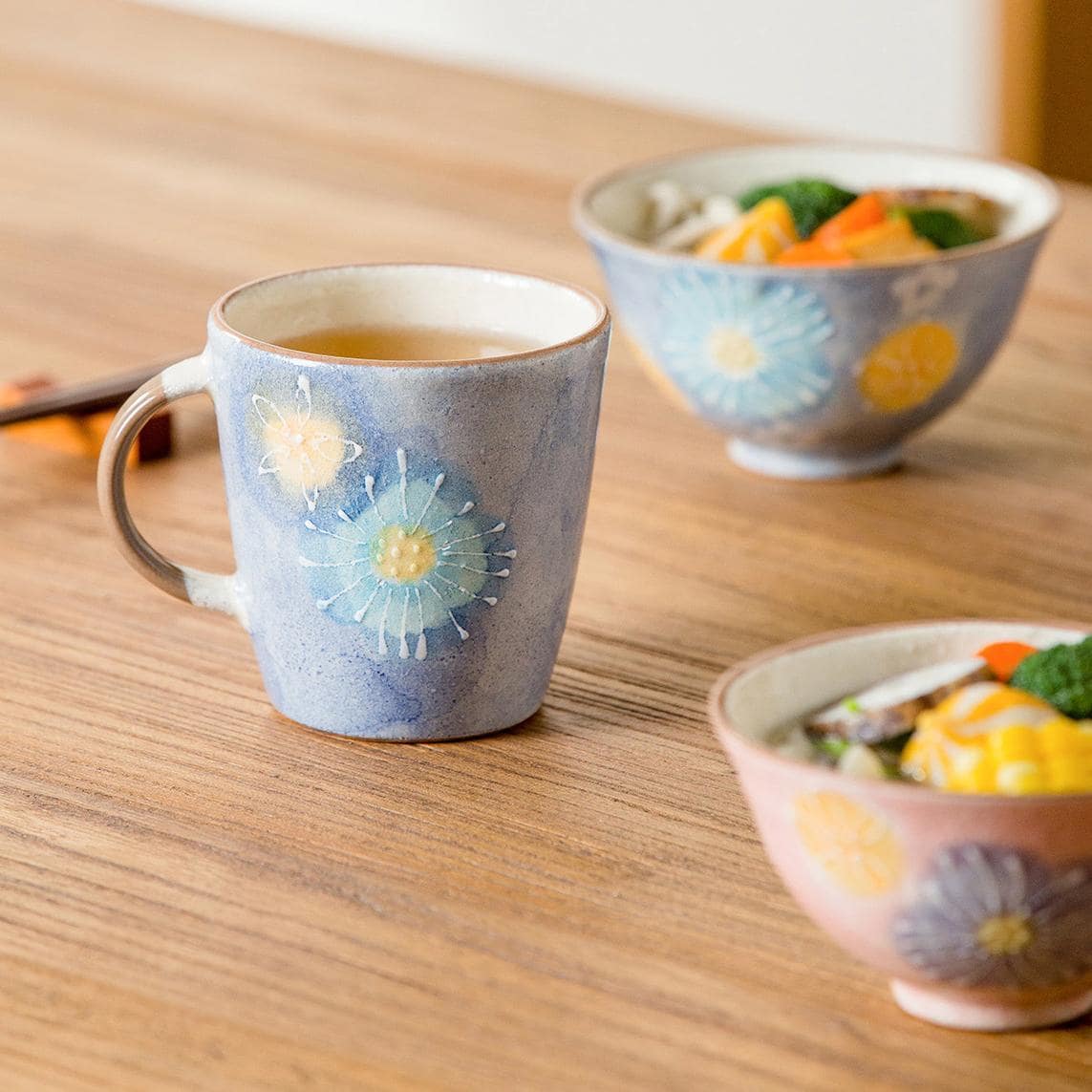 Pair of pink and blue ceramic cups with delicate flower designs