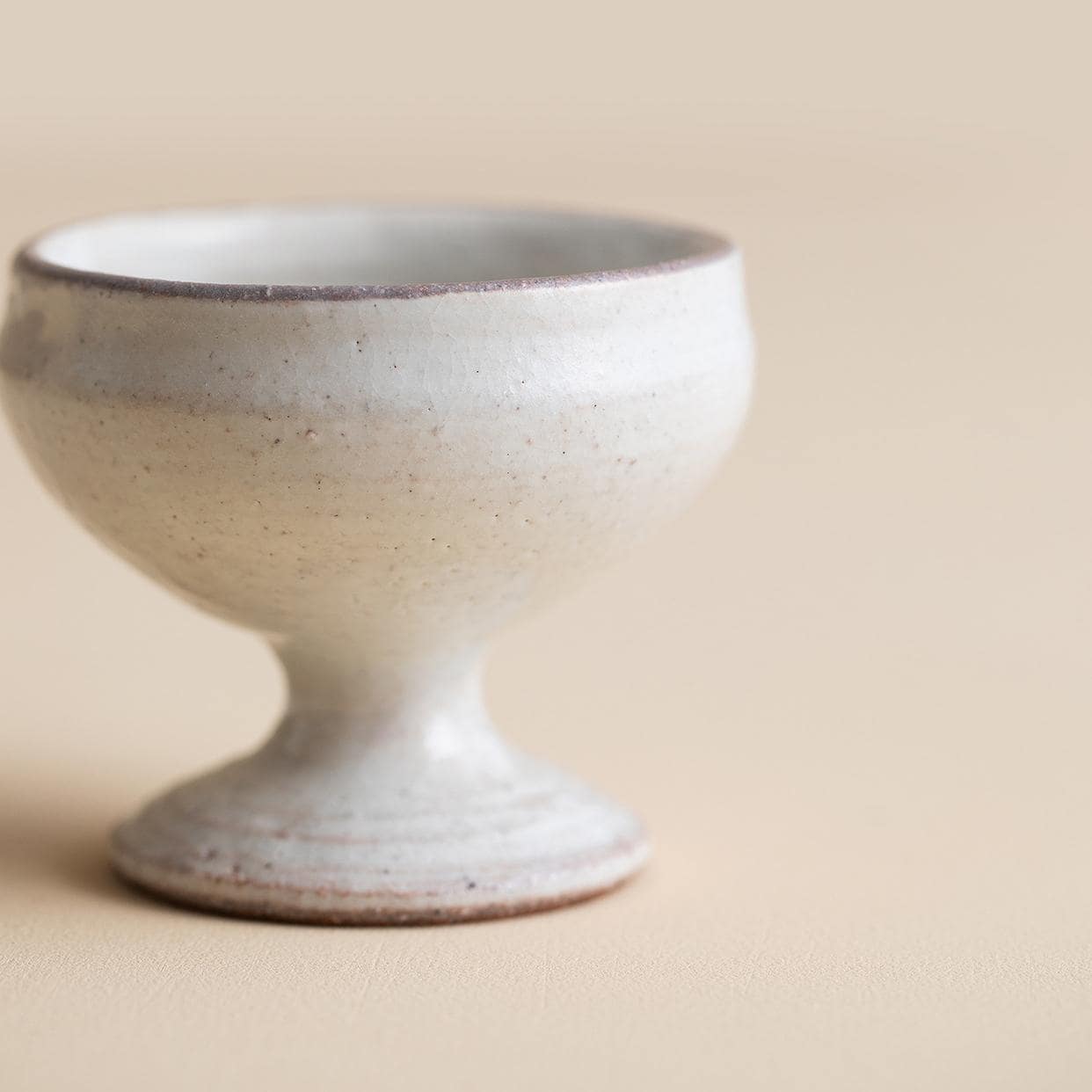 Artisan ceramic cup with a pedestal base and unique pattern