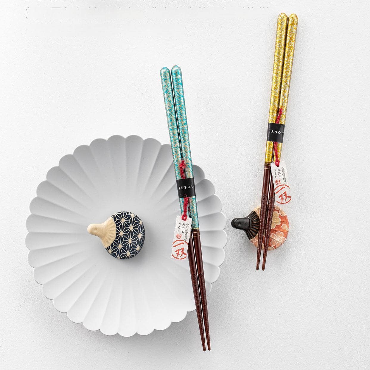 High-value Japanese chopsticks placed on a ceramic dish.