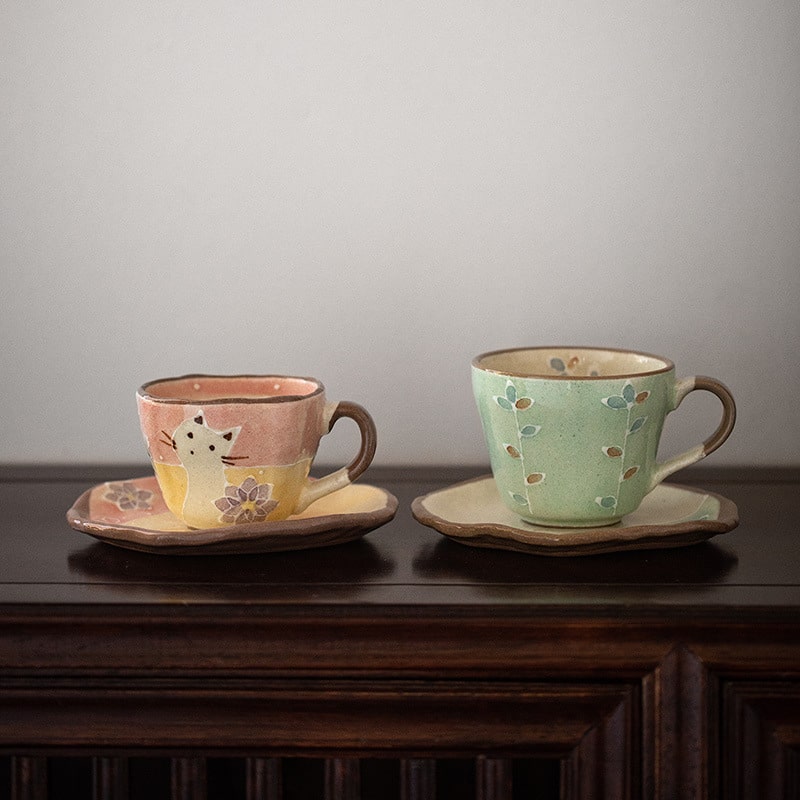 Hand-painted ceramic coffee cup with floral design