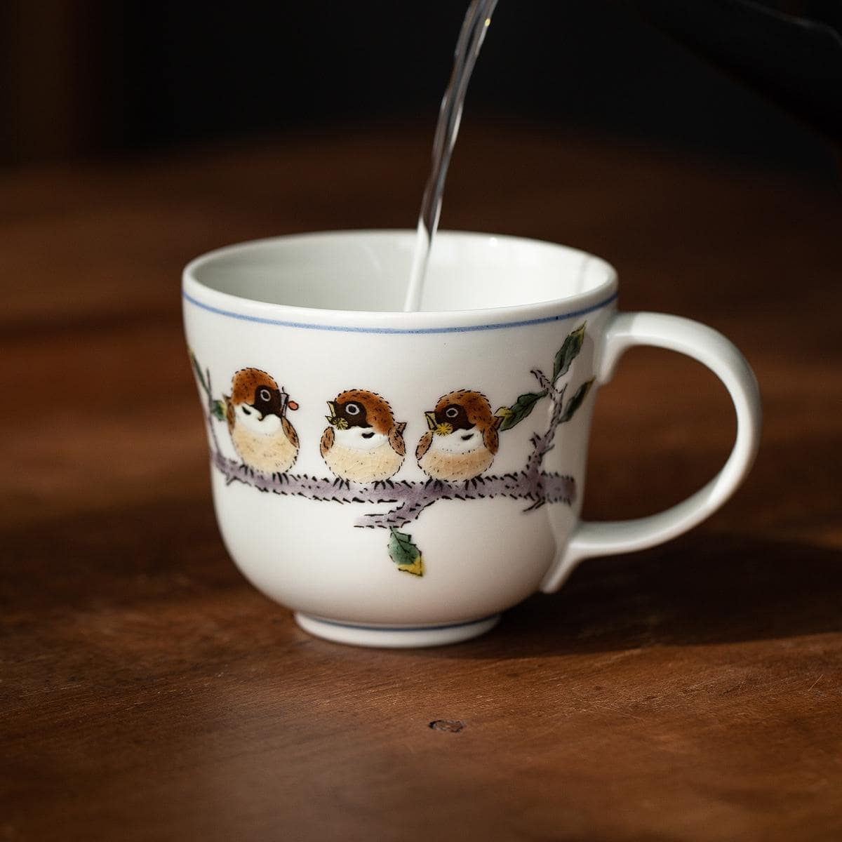 Japanese ceramic cup with delicate sparrow illustrations