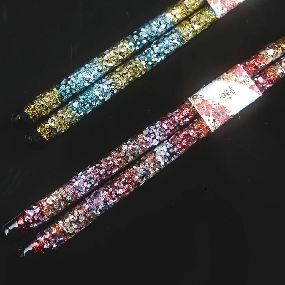 Close-up of premium chopsticks with shimmering floral design.