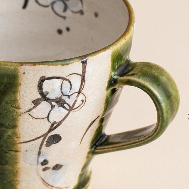 Close-up of a Japanese teacup showcasing floral hand-painted design