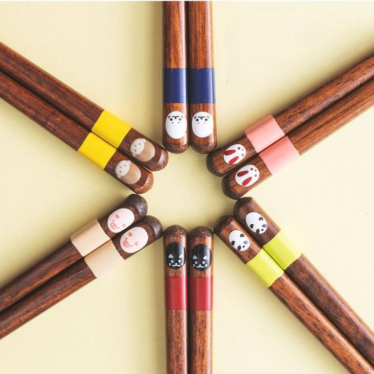 Colorful animal-themed wooden chopsticks arranged in a set