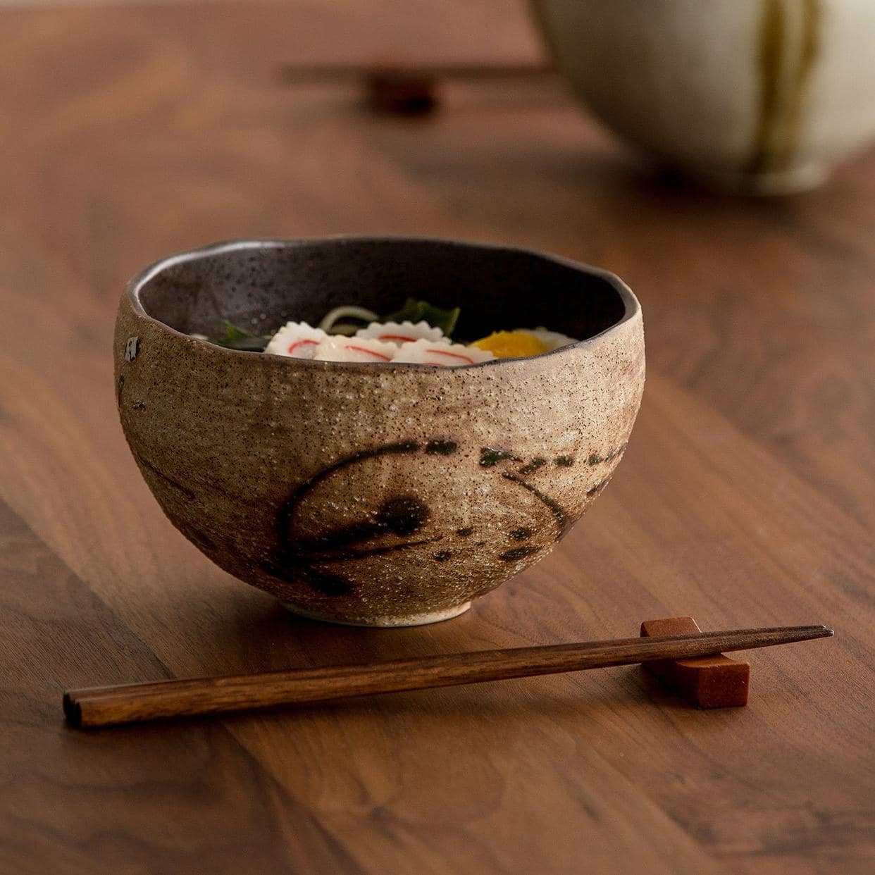 Rustic handmade ceramic bowl with earthy tones.