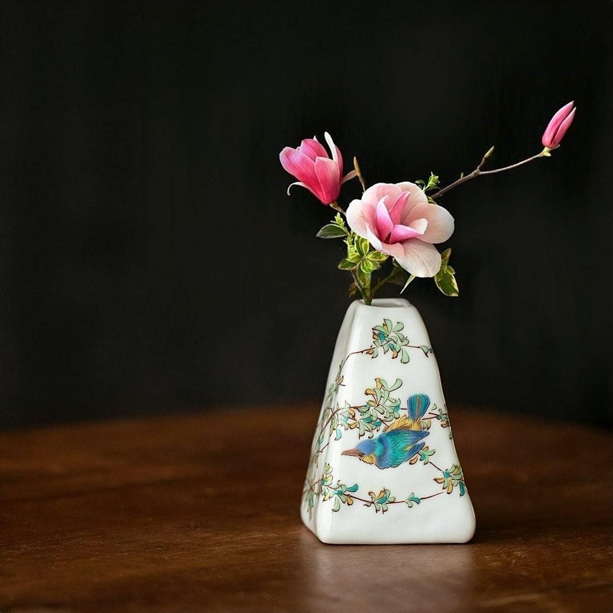 Hand-painted triangular ceramic vase with delicate floral patterns