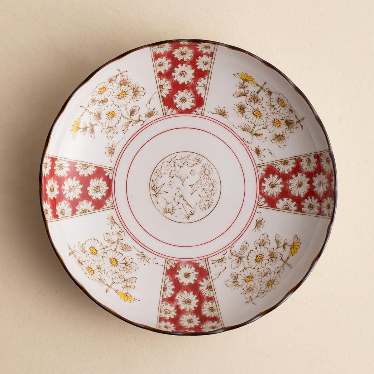 Close-up of Renfeng style tableware showcasing red and gold patterns