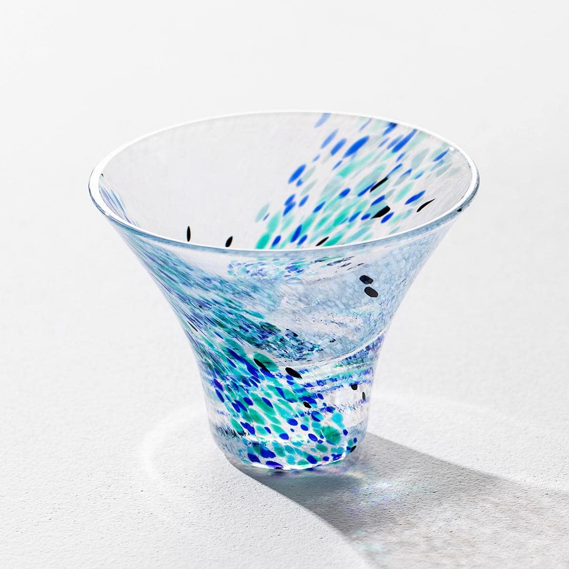 Overhead view of artistic glass cups with colorful patterns